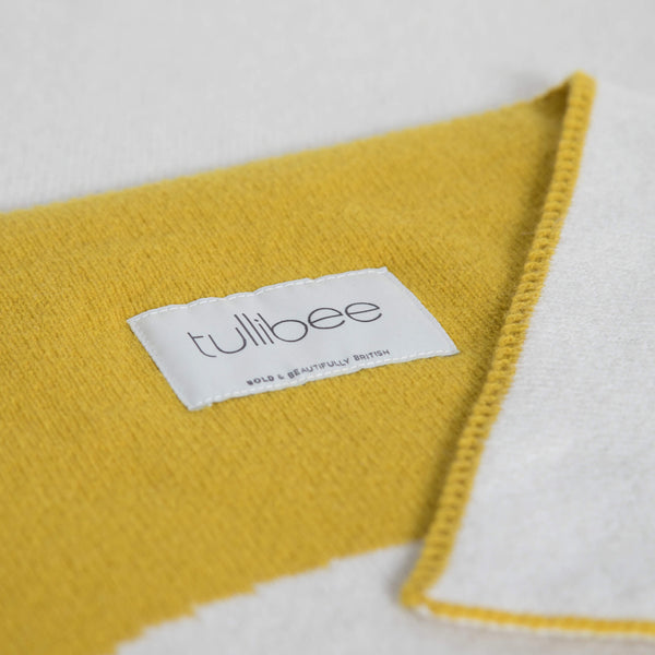 tullibee knitted blanket WOW mustard brand label close up