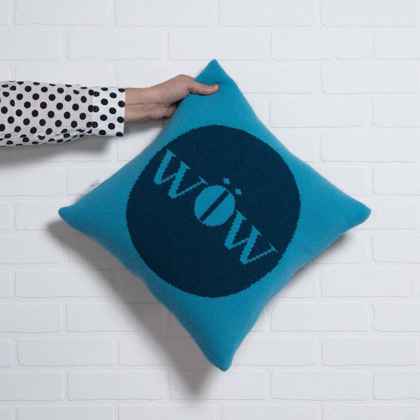 tullibee knitted cushion WOW blue holding