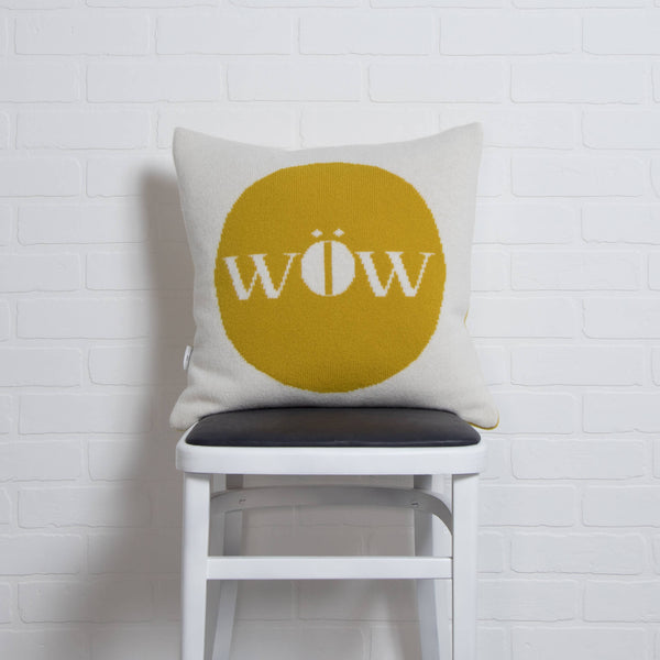 tullibee knitted cushion WOW mustard on chair