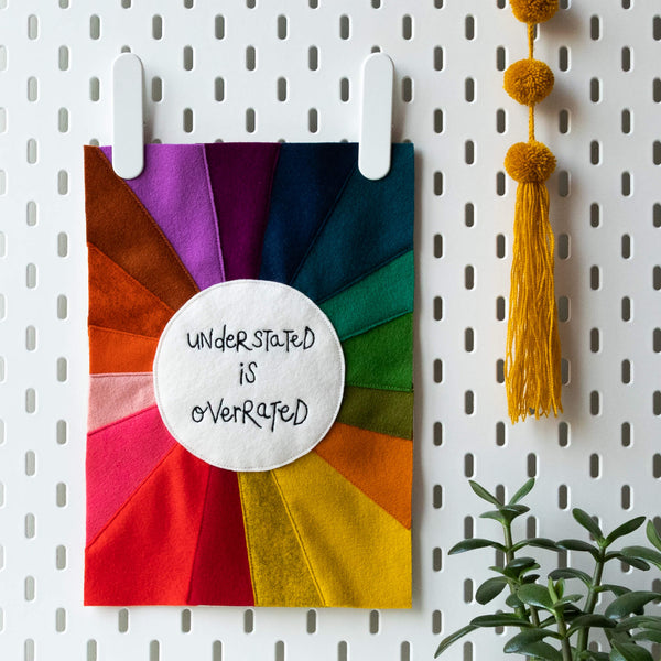 'UNDERSTATED IS OVERRATED' RAINBOW TEXTILE ARTWORK