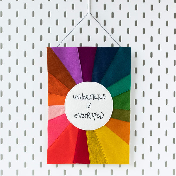 'UNDERSTATED IS OVERRATED' RAINBOW TEXTILE ARTWORK