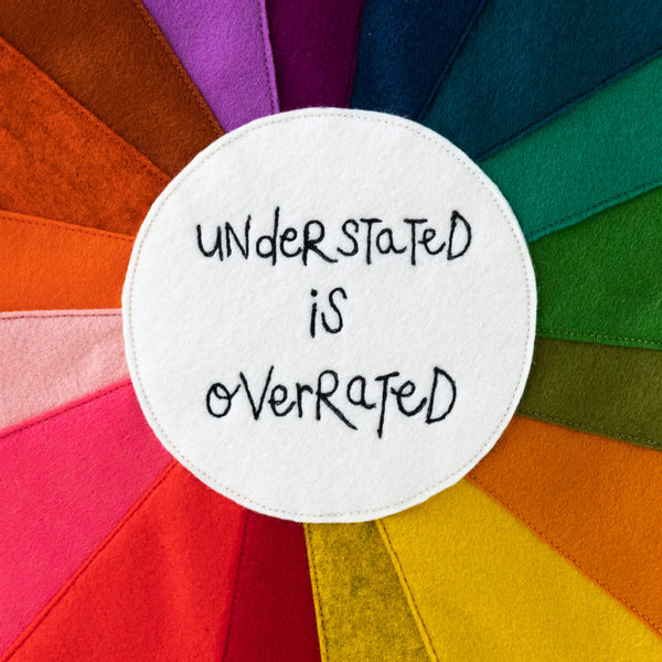 'UNDERSTATED IS OVERRATED' RAINBOW TEXTILE ARTWORK