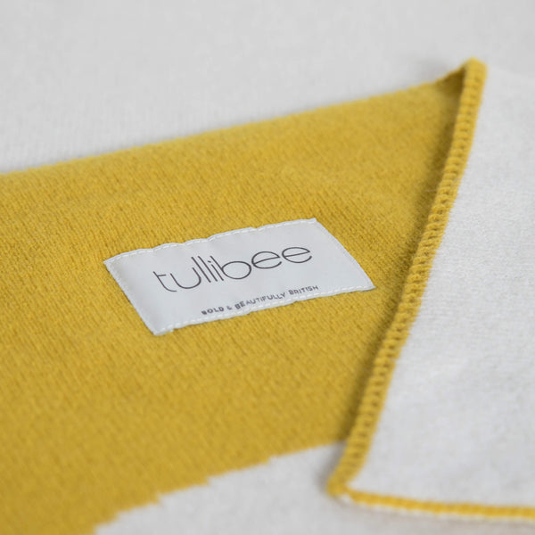 tullibee knitted blanket WOW mustard brand label close up