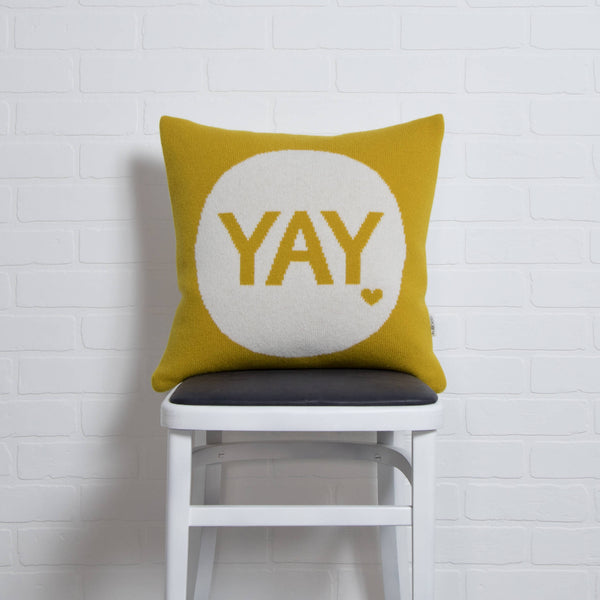 tullibee knitted cushion YAY mustard on chair
