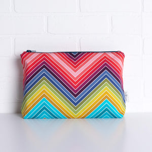 tullibee marni rainbow zig-zag maxi pouch in front of a white brick wall (front view)